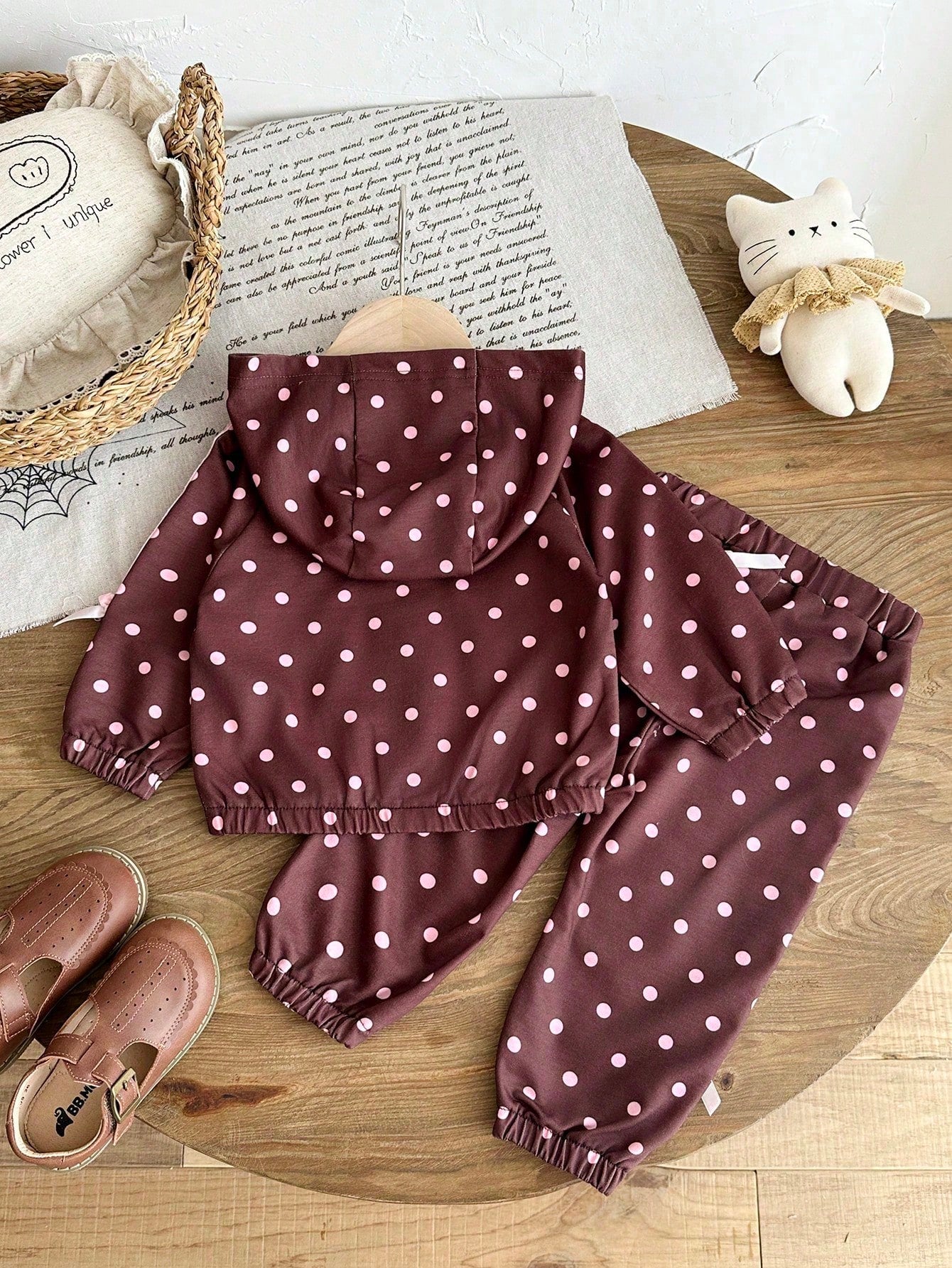Girls Hooded Two Pieces Tracksuit In Brown With Pink Polka Dots. Full-Zip Hooded Jacket And Cuffed Jogger Pants Decorated With Pink Ribbons And Bows.